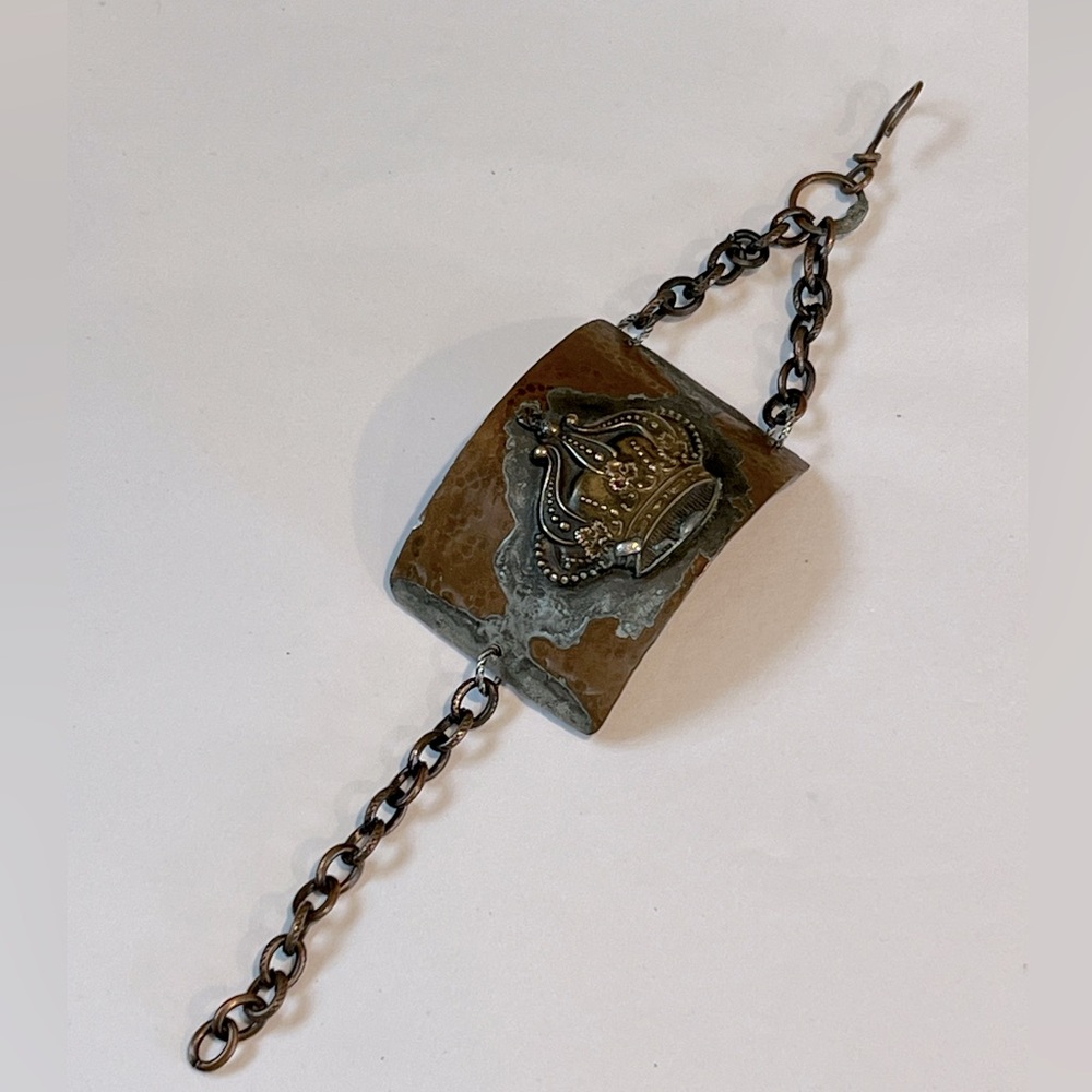 Cuff-like bracelet with chain closure. Costume jewelry. 8” length.